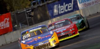 A nascar car races down a track