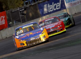 A nascar car races down a track