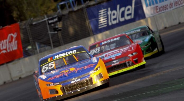 A nascar car races down a track