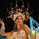 A carnival queen dances in an elaborate starfish costume