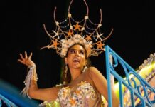 A carnival queen dances in an elaborate starfish costume