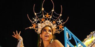A carnival queen dances in an elaborate starfish costume