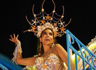 A carnival queen dances in an elaborate starfish costume
