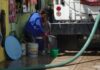 man with hose indoors