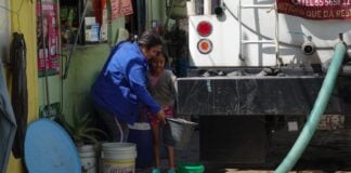 man with hose indoors