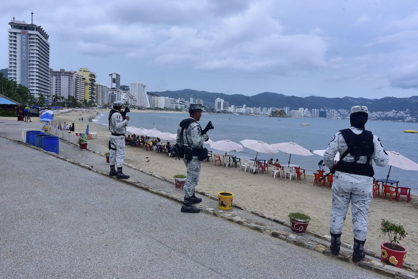 Uniformed men guarding beach