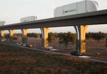 A rendering shows cargo containers moving along an automated freight corridor guideway above a highway