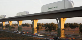 A rendering shows cargo containers moving along an automated freight corridor guideway above a highway