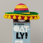 A bottle of oatly oat milk in a mexican sombrero