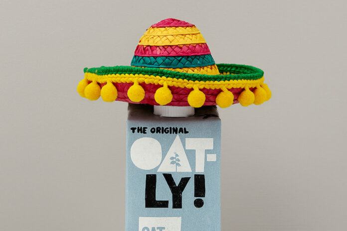 A bottle of oatly oat milk in a mexican sombrero