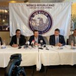 men seated behind a table