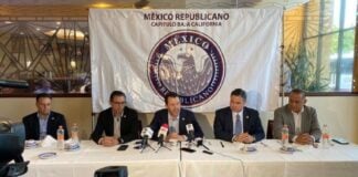 men seated behind a table