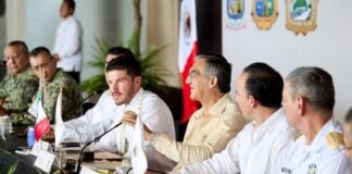 several men seated at a dais