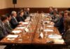 men in suits seated around a conference table at G7