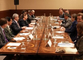 men in suits seated around a conference table at G7