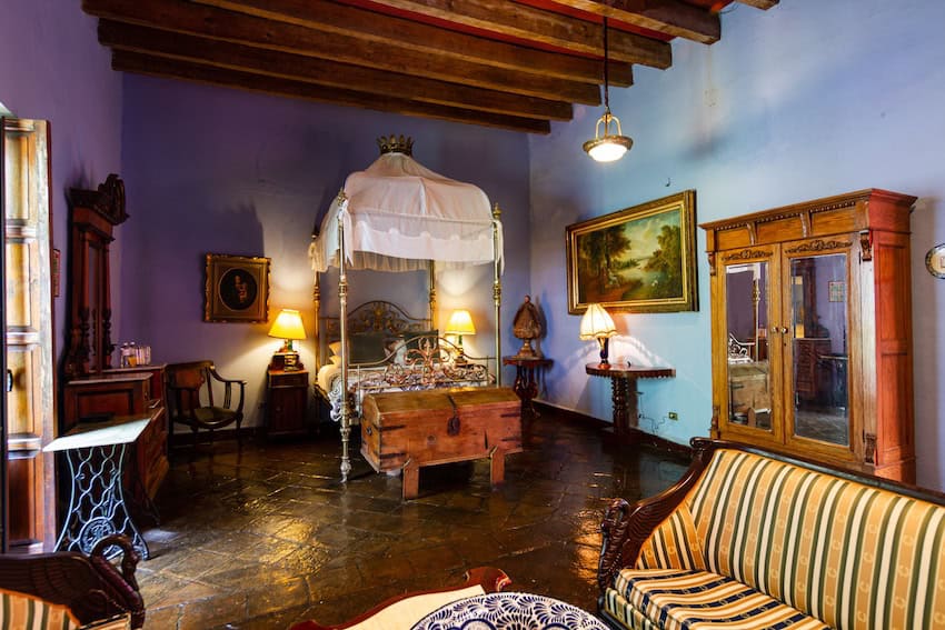 A hotel room decorated in period Mexican colonial furniture in a 250 year old mansion in Puebla city