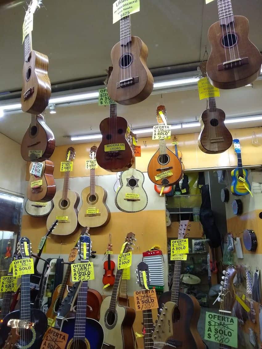 Guitars hang from roof in music store