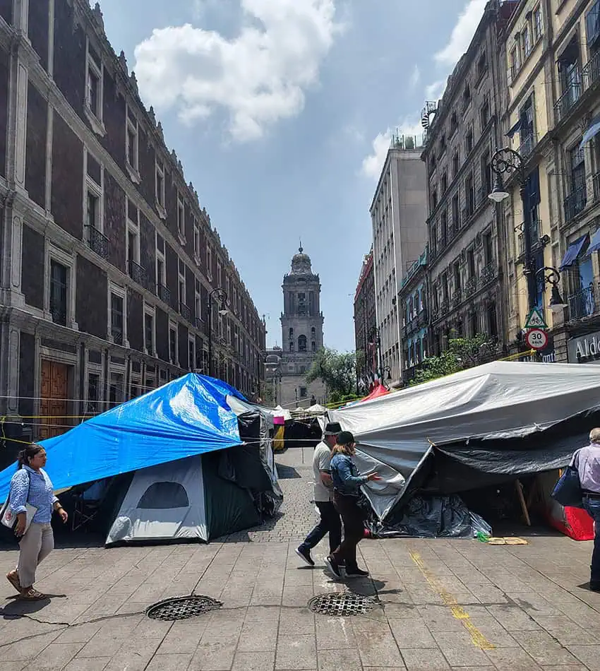 A view of the Mexico City cathedral from the zocalo, with protest tents pitched in the foreground