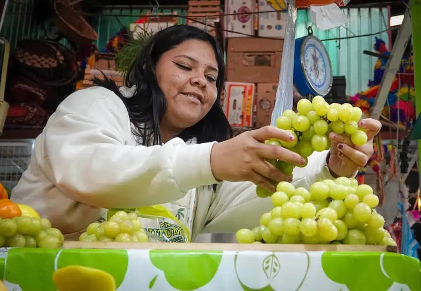 Woman inspects grapes