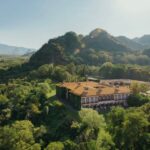 Aerial view of Hacienda de San Antonio with mountain backdrop including the Colima Volcano