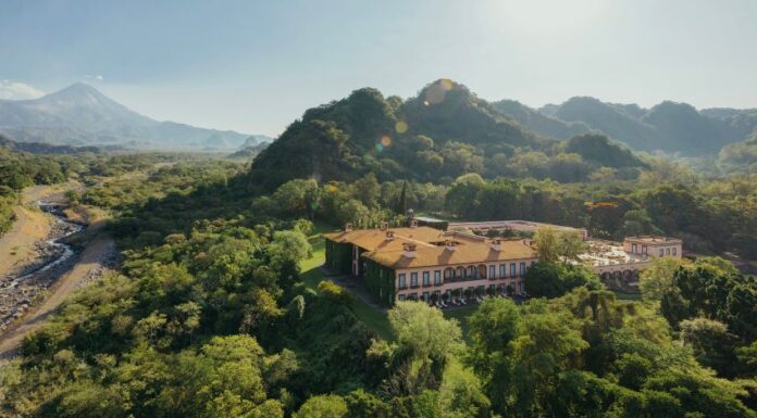 Aerial view of Hacienda de San Antonio with mountain backdrop including the Colima Volcano