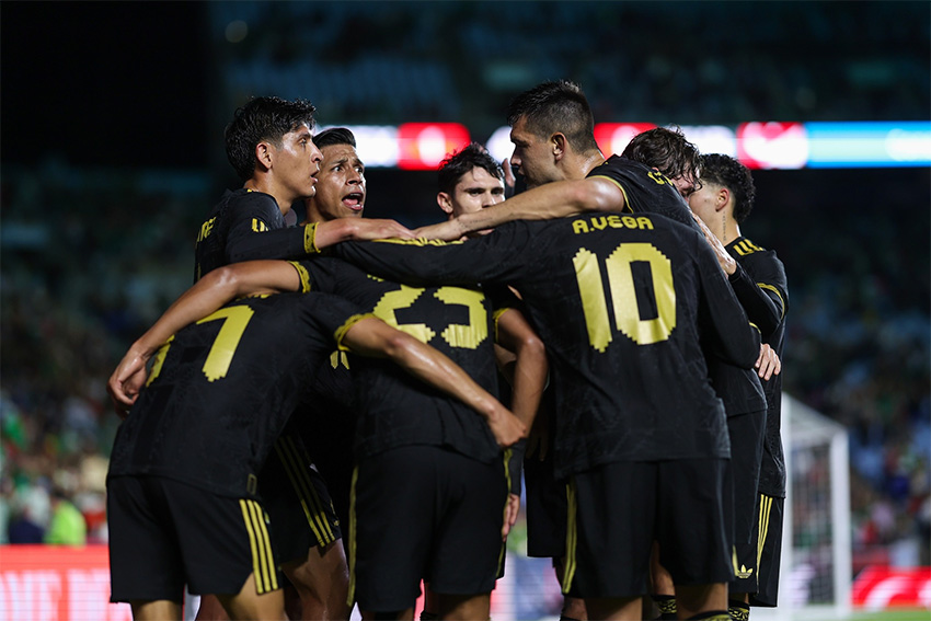 Mexico's national soccer team huddles during a game