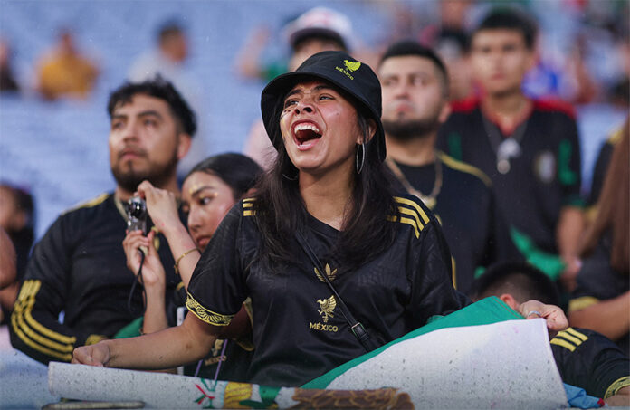 A soccer fan screams at a Mexico vs Turkey match