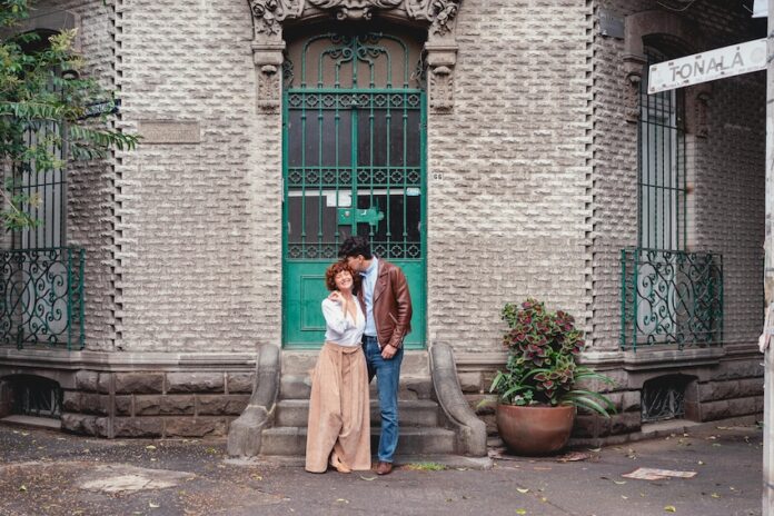 Couple stands on street corner in Mexico City