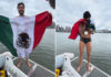 Mexican open water swimmer David Olvera stands on a boat in front of Manhattan Island in a swim suit, waving a Mexican flag