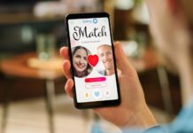 A hand holds a phone showing a dating app match screen