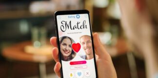 A hand holds a phone showing a dating app match screen