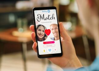 A hand holds a phone showing a dating app match screen