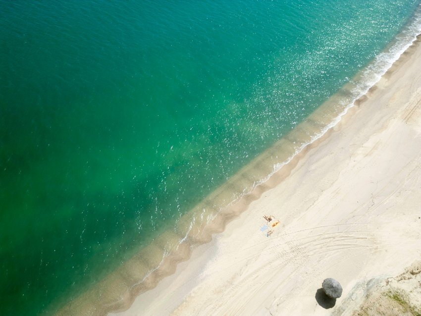 Baja California se trouve du haut d'une côte côtière unique, du sable blanc vide et de l'eau turquoise sur le rivage.