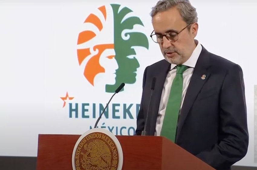 man in green tie at microphone