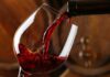 Red wine pours into a glass