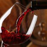 Red wine pours into a glass