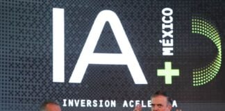 two men at podium with IA (AI in English) iage behind them.