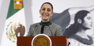 President Sheinbaum smiles from the podium of her morning press conference