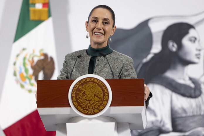 President Sheinbaum smiles from the podium of her morning press conference