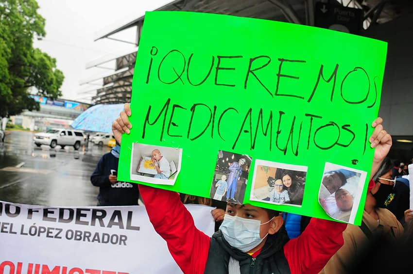 A kid holds a motion speechmaking "Queremos medicamento" astatine a protest