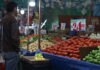 A man looks at produce in a Mexican market