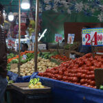A man looks at produce in a Mexican market