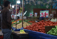 A man looks at produce in a Mexican market