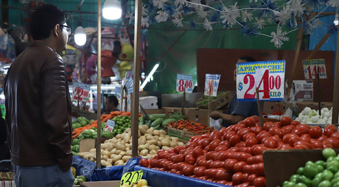 A man looks at produce in a Mexican market