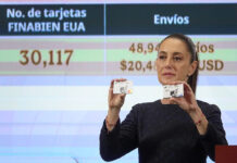 Sheinbaum displays a Finabien bank card
