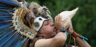 Shaman blowing conch horn