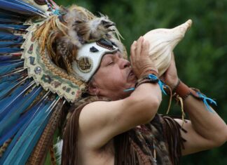 Shaman blowing conch horn