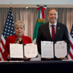Alicia Bárcena and Zeldin hold up copies of a signed agreement to fund sewage treatment for the Tijuana River