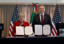 Alicia Bárcena and Zeldin hold up copies of a signed agreement to fund sewage treatment for the Tijuana River