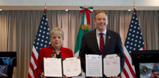 Alicia Bárcena and Zeldin hold up copies of a signed agreement to fund sewage treatment for the Tijuana River